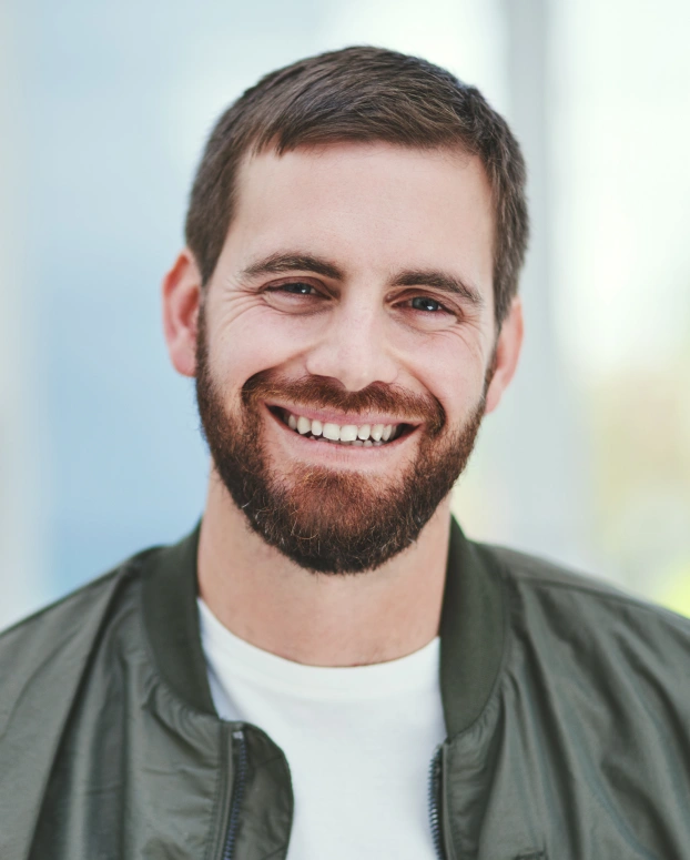 Adult patient smiling during a routine dental visit at a modern dental office.