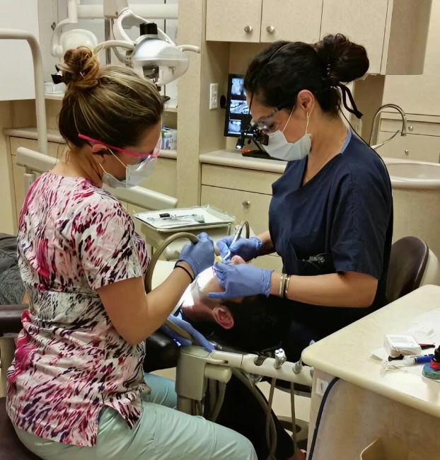 Dentist providing emergency dental care to a patient at Newark Smiles Dental