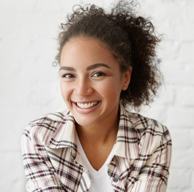 Teen patient smiling during a preventive dental care appointment.