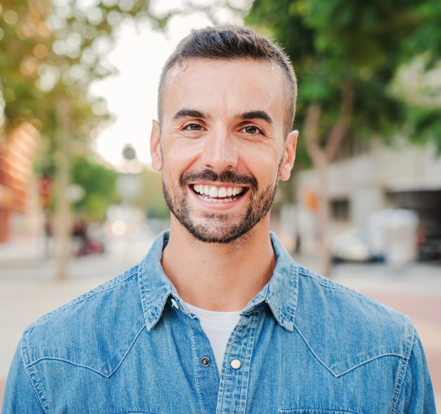 Patient smiling after a professional teeth cleaning and dental exam.