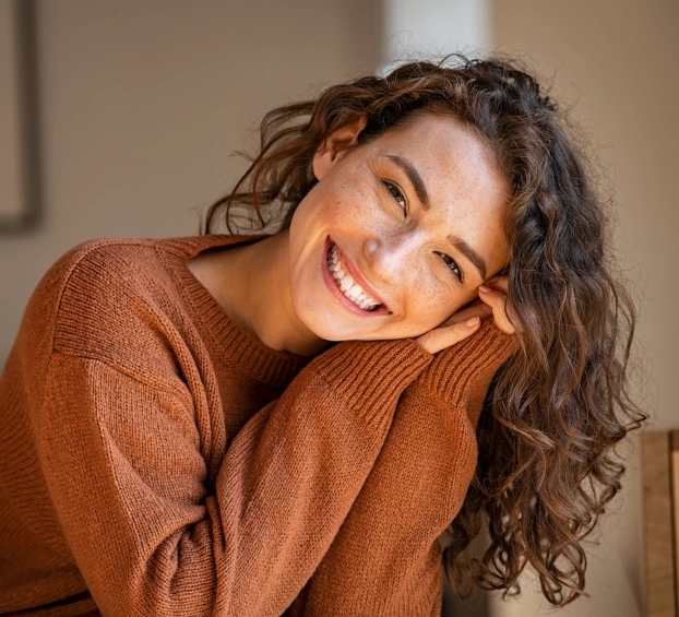 Woman smiling after cosmetic dentistry treatment