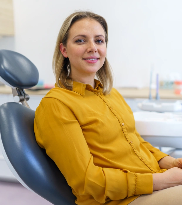 Patient smiling during a periodontal therapy consultation for healthier gums.