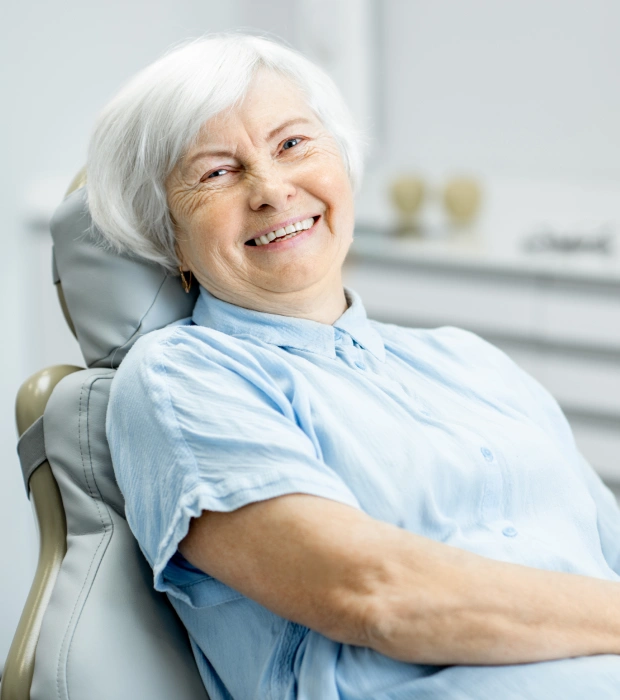 Senior patient smiling after root canal treatment