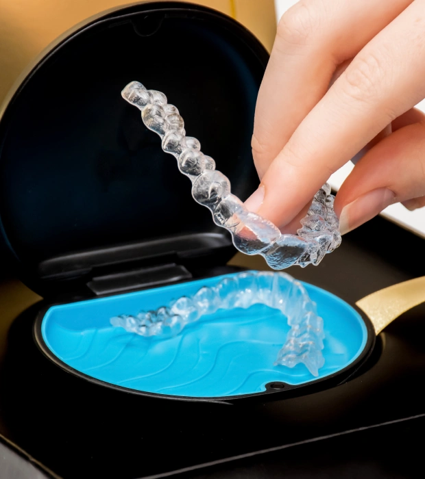 Clear Invisalign aligner being removed from its case